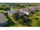 Aerial image of the house backyard showing a well-manicured lawn, professional landscaping, and screened in porch at 7432 Sw 98Th Ave, Ocala, FL 34481