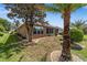 Home exterior featuring a screened-in lanai and manicured landscaping at 7432 Sw 98Th Ave, Ocala, FL 34481