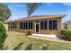 Home exterior featuring a screened-in lanai and manicured landscaping at 7432 Sw 98Th Ave, Ocala, FL 34481
