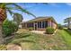 Home exterior featuring a screened-in lanai and manicured landscaping at 7432 Sw 98Th Ave, Ocala, FL 34481
