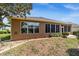 Home exterior featuring a screened-in lanai and manicured landscaping at 7432 Sw 98Th Ave, Ocala, FL 34481