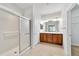 Bathroom featuring a double vanity, tiled floors, and a glass-enclosed shower at 7432 Sw 98Th Ave, Ocala, FL 34481