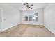 Comfortable bedroom with neutral carpet, ceiling fan, and natural light at 7432 Sw 98Th Ave, Ocala, FL 34481