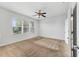 Bright bedroom with a ceiling fan and a large window overlooking the yard at 7432 Sw 98Th Ave, Ocala, FL 34481