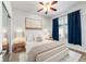 Comfortable bedroom features a ceiling fan, soft lighting, and ample space for relaxation at 7432 Sw 98Th Ave, Ocala, FL 34481