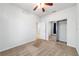 Carpeted bedroom featuring a ceiling fan, closet and view to another room at 7432 Sw 98Th Ave, Ocala, FL 34481