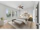 Serene bedroom featuring a ceiling fan, cozy bed, and abundant natural light at 7432 Sw 98Th Ave, Ocala, FL 34481