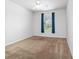 Bedroom with neutral walls, carpeted floors, and a window offering natural light at 7432 Sw 98Th Ave, Ocala, FL 34481