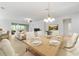 Bright dining area with modern chandelier and a view of the cozy living space at 7432 Sw 98Th Ave, Ocala, FL 34481