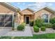 Inviting home exterior showcases manicured shrubs and a covered front entrance at 7432 Sw 98Th Ave, Ocala, FL 34481