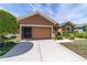 Charming single-story home featuring an attached two-car garage and meticulous landscaping at 7432 Sw 98Th Ave, Ocala, FL 34481