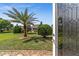 Inviting home entrance with lush lawn, palm tree, and decorative stonework at 7432 Sw 98Th Ave, Ocala, FL 34481