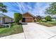Single-story home with manicured landscaping, functional two-car garage, and a spacious driveway at 7432 Sw 98Th Ave, Ocala, FL 34481