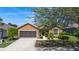 One-story home boasts a neatly kept front yard, a two-car garage, and a convenient driveway at 7432 Sw 98Th Ave, Ocala, FL 34481