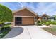 One-story home featuring a functional garage, meticulously landscaped front yard, and a spacious driveway at 7432 Sw 98Th Ave, Ocala, FL 34481