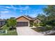 Well kept one-story home featuring a two-car garage, lush landscaping, and a spacious driveway at 7432 Sw 98Th Ave, Ocala, FL 34481