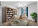 Bright home office with a large bookcase and comfortable workspace for productivity at 7432 Sw 98Th Ave, Ocala, FL 34481
