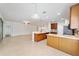 Bright kitchen featuring wood cabinets, stainless steel appliances, and breakfast bar at 7432 Sw 98Th Ave, Ocala, FL 34481
