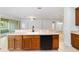 Kitchen with a breakfast bar, black dishwasher, and faucet at 7432 Sw 98Th Ave, Ocala, FL 34481