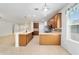 Bright, open kitchen with stainless steel appliances, wood cabinets, and breakfast bar at 7432 Sw 98Th Ave, Ocala, FL 34481