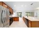 Bright, open kitchen with stainless steel appliances, tile floors, and wood cabinets at 7432 Sw 98Th Ave, Ocala, FL 34481