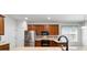 Bright kitchen featuring stainless steel appliances, mosaic backsplash, and wood cabinets at 7432 Sw 98Th Ave, Ocala, FL 34481
