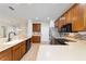 Bright kitchen featuring wood cabinets, stainless steel appliances, and breakfast bar at 7432 Sw 98Th Ave, Ocala, FL 34481