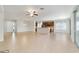 Bright open-concept living room with tile flooring, ceiling fan, and sliding glass doors to a patio at 7432 Sw 98Th Ave, Ocala, FL 34481