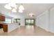 Open-concept living area provides views of the kitchen, breakfast bar and screened-in lanai at 7432 Sw 98Th Ave, Ocala, FL 34481