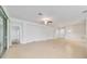 Spacious living room with tile flooring, ceiling fan, and sliding glass doors at 7432 Sw 98Th Ave, Ocala, FL 34481