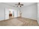 Carpeted main bedroom with en-suite bathroom access at 7432 Sw 98Th Ave, Ocala, FL 34481