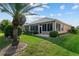 Exterior view of the home's screened-in porch and lush backyard at 7432 Sw 98Th Ave, Ocala, FL 34481