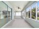 Bright sunroom featuring large windows, neutral carpeting, and a ceiling fan at 7432 Sw 98Th Ave, Ocala, FL 34481