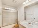 Bathroom featuring a shower with glass doors and a sink vanity with storage space at 8051 Sw 115 Loop, Ocala, FL 34481