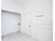 Utility area featuring tile flooring, white walls, and a door at 8051 Sw 115 Loop, Ocala, FL 34481