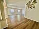 Bright living room with hardwood flooring, large windows, and a decorative chandelier at 8051 Sw 115 Loop, Ocala, FL 34481