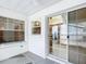 A covered patio with tiled floors, a sliding glass door, and windows offering natural light at 8051 Sw 115 Loop, Ocala, FL 34481
