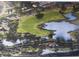 Aerial view of a lush golf course winding through a residential community with scenic ponds and mature trees at 8132 Fairways Cir # R103, Ocala, FL 34472