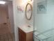 Updated bathroom features a wood vanity, tiled floor, and framed turtle art at 8132 Fairways Cir # R103, Ocala, FL 34472