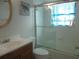 Bright bathroom featuring a shower over tub with a glass door and updated vanity at 8132 Fairways Cir # R103, Ocala, FL 34472