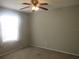 Carpeted bedroom with ceiling fan and natural light from a window at 8132 Fairways Cir # R103, Ocala, FL 34472