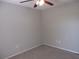 A carpeted bedroom has a ceiling fan, neutral paint, and electrical outlets at 8132 Fairways Cir # R103, Ocala, FL 34472