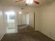 Bedroom featuring mirrored closet doors, carpeted floor, ceiling fan and en-suite bathroom at 8132 Fairways Cir # R103, Ocala, FL 34472