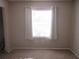 Carpeted bedroom with a window featuring sheer curtains at 8132 Fairways Cir # R103, Ocala, FL 34472