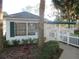Charming clubhouse exterior with green shutters, white picket fence, and lovely landscaping at 8132 Fairways Cir # R103, Ocala, FL 34472