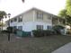 Two-story condo with green shutters, landscaping, and a quaint exterior at 8132 Fairways Cir # R103, Ocala, FL 34472