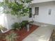 Charming front yard featuring lush landscaping, a decorative statue, and a peaceful ambiance at 8132 Fairways Cir # R103, Ocala, FL 34472