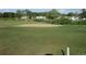 Wide shot of a golf course, featuring a large sand trap and distant houses at 8132 Fairways Cir # R103, Ocala, FL 34472