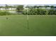 Well-kept golf green with a hole, flag, and residences in the backdrop at 8132 Fairways Cir # R103, Ocala, FL 34472