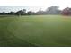 Expansive golf green featuring a golf cart and manicured grass at 8132 Fairways Cir # R103, Ocala, FL 34472
